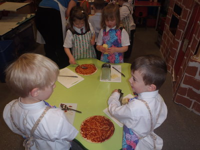 Image of Children making pizzas and the grand opening of the pizza parlour